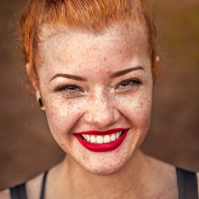 Woman with red hair and freckles laughing